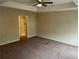 Spacious bedroom with tray ceilings, recessed lighting, and a carpeted floor at 3140 Tylerton Sw Dr, Atlanta, GA 30311