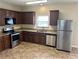 Well-equipped kitchen with stainless steel appliances and dark wooden cabinets at 3140 Tylerton Sw Dr, Atlanta, GA 30311