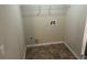 Functional laundry room with linoleum flooring, overhead rack, and hookups at 3140 Tylerton Sw Dr, Atlanta, GA 30311