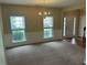 Bright open living room featuring carpet, windows, decorative molding, and front entry at 3140 Tylerton Sw Dr, Atlanta, GA 30311