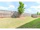 Well-maintained backyard featuring a privacy fence, green grass, and landscaping at 3397 Long Creek Drive, Buford, GA 30519