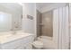 Bright bathroom featuring a white vanity, toilet, and a tiled shower-tub combo with a shower curtain at 3397 Long Creek Drive, Buford, GA 30519