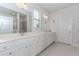 Spacious bathroom with double sinks, granite countertops, and a large mirror at 3397 Long Creek Drive, Buford, GA 30519