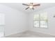 A brightly lit bedroom featuring carpeted floors and a large window at 3397 Long Creek Drive, Buford, GA 30519
