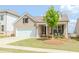 Charming single-Gathering home with a well-manicured front lawn, a two-car garage, and a cozy front porch at 3397 Long Creek Drive, Buford, GA 30519