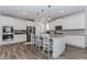 A modern kitchen showcasing stainless steel appliances, granite countertops, and a central island with bar seating at 3397 Long Creek Drive, Buford, GA 30519