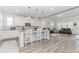 Open kitchen with a large island, stainless appliances, and adjacent living area at 3397 Long Creek Drive, Buford, GA 30519