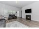 Cozy living room featuring a fireplace and modern furnishings at 3397 Long Creek Drive, Buford, GA 30519