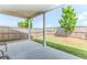 Covered patio overlooking a fenced yard with green grass and a young shade tree at 3397 Long Creek Drive, Buford, GA 30519