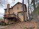 Back exterior view of home with a wood deck overlooking the yard at 7592 Watson Kaye, Stone Mountain, GA 30087