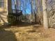 View of the backyard featuring an elevated deck and a backdrop of trees at 7592 Watson Kaye, Stone Mountain, GA 30087