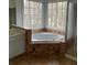Bright bathroom featuring a garden tub surrounded by patterned tile and a large window at 7592 Watson Kaye, Stone Mountain, GA 30087