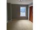 Bedroom with light-grey walls, a window, light colored carpet and built-in closet at 7592 Watson Kaye, Stone Mountain, GA 30087