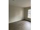 Bedroom with hardwood floors, light walls, and large picture window at 7592 Watson Kaye, Stone Mountain, GA 30087