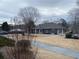 Exterior of community clubhouse with sidewalks and landscape at 7592 Watson Kaye, Stone Mountain, GA 30087