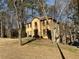 Home nestled among mature trees, featuring a tidy lawn and inviting curb appeal at 7592 Watson Kaye, Stone Mountain, GA 30087