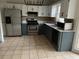 Well-lit kitchen featuring stainless steel appliances, two-tone cabinets, and tile flooring at 7592 Watson Kaye, Stone Mountain, GA 30087