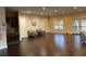 Large community room with two armchairs, refreshment area, and doors to the exterior at 7592 Watson Kaye, Stone Mountain, GA 30087