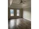 Spacious main bedroom with tray ceiling, ceiling fan, and wood-look flooring at 7592 Watson Kaye, Stone Mountain, GA 30087