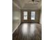 Spacious main bedroom with tray ceiling and hardwood floors, complemented by natural light at 7592 Watson Kaye, Stone Mountain, GA 30087