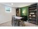 Basement dining nook featuring a table with four chairs, a lamp, and built-in bookshelves at 2640 Spring Se Dr, Smyrna, GA 30080