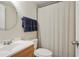 Functional bathroom featuring a single sink vanity, a mirror, and a shower with a curtain at 2640 Spring Se Dr, Smyrna, GA 30080