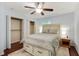 Cozy bedroom with hardwood floors, a ceiling fan, closet, and a comfortable queen bed at 2640 Spring Se Dr, Smyrna, GA 30080