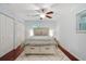 Bedroom featuring hardwood floors, a ceiling fan, and a comfortable king-sized bed at 2640 Spring Se Dr, Smyrna, GA 30080