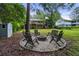 Backyard firepit with chairs, creating an inviting space for outdoor entertaining surrounded by beautiful trees at 2640 Spring Se Dr, Smyrna, GA 30080