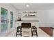 Bright kitchen area featuring bar top counter with stools and sliding doors to the deck at 2640 Spring Se Dr, Smyrna, GA 30080