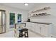 Bright eat-in kitchen area featuring bar top counter with stools, stainless appliances, and sliding doors to the deck at 2640 Spring Se Dr, Smyrna, GA 30080