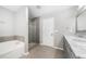 Beautiful bathroom with a soaking tub, glass shower, and double vanity with marble countertops at 4188 Cookcreek Place Northwest Nw Pl, Lilburn, GA 30047