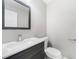 Modern bathroom with gray vanity, white countertops, and a rectangular framed mirror at 4188 Cookcreek Place Northwest Nw Pl, Lilburn, GA 30047