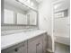 Charming bathroom with marble countertops and a stylish vanity. Bathtub/shower in the background at 4188 Cookcreek Place Northwest Nw Pl, Lilburn, GA 30047