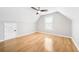 Attic bedroom with wood floors, a ceiling fan, and natural light from a window at 4188 Cookcreek Place Northwest Nw Pl, Lilburn, GA 30047