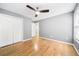 Light and airy bedroom featuring beautiful wood floors, a ceiling fan, and a closet at 4188 Cookcreek Place Northwest Nw Pl, Lilburn, GA 30047