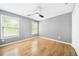 Bedroom with wood floors, neutral paint, and natural light from two windows at 4188 Cookcreek Place Northwest Nw Pl, Lilburn, GA 30047