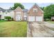 Charming brick home with a well-manicured lawn and a two-car garage at 4188 Cookcreek Place Northwest Nw Pl, Lilburn, GA 30047