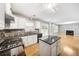 Stylish kitchen with granite island open to a large living area at 4188 Cookcreek Place Northwest Nw Pl, Lilburn, GA 30047