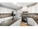 Modern kitchen with granite countertops and stainless steel appliances at 4188 Cookcreek Place Northwest Nw Pl, Lilburn, GA 30047