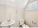 Cozy powder room with toilet, sink, towel rack, and a window at 4593 Parkway Cir, Atlanta, GA 30349