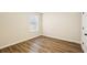 Bedroom featuring a window, closet door, and wood floors at 4593 Parkway Cir, Atlanta, GA 30349