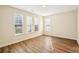 This bedroom offers wood floors, light walls, and plenty of natural light from large windows at 4593 Parkway Cir, Atlanta, GA 30349