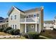 Charming two-story home with a balcony, light green siding, a well-manicured lawn and a blue front door at 4593 Parkway Cir, Atlanta, GA 30349