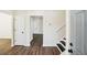 The foyer welcomes with wood floors, white walls, and a staircase with white railing and black treads at 4593 Parkway Cir, Atlanta, GA 30349