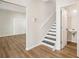 The foyer includes a powder room, and features wood floors and black and white stairs at 4593 Parkway Cir, Atlanta, GA 30349