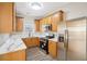 Well-lit kitchen with stainless steel appliances, modern countertops, light wood cabinets, and wood floors at 4593 Parkway Cir, Atlanta, GA 30349