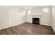 Cozy living room with wood floors, white fireplace, neutral walls, and a sliding glass door at 4593 Parkway Cir, Atlanta, GA 30349