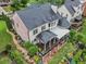 A manicured backyard featuring a spacious covered patio, lush lawn, and a privacy fence at 7060 Summit Ridge Chase, Cumming, GA 30041