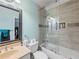 Remodeled bathroom with a shower-tub combo, modern fixtures, and built-in shelving at 7060 Summit Ridge Chase, Cumming, GA 30041